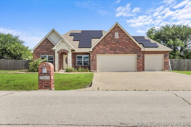 23609 E 135th St, Coweta, OK 74429 - traditional home featuring roof mounted solar panels, an attached garage, driveway, brick siding, and roof with shingles