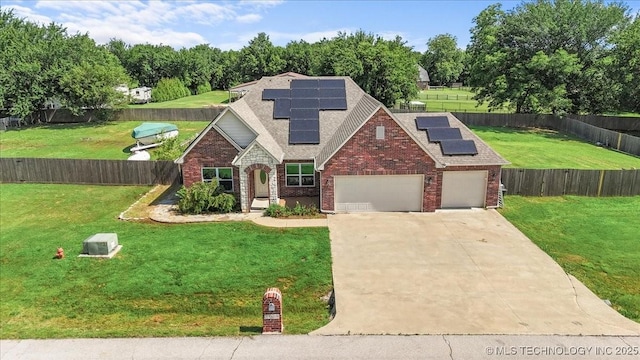 23609 E 135th St, Coweta, OK 74429 - traditional home with brick siding, driveway, a garage, roof mounted solar panels, and a shingled roof