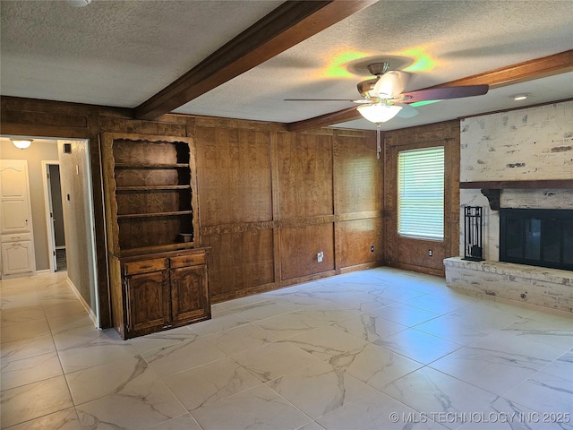 12717 E 133rd Pl S, Broken Arrow, OK 74011 - unfurnished living room with a textured ceiling, wooden walls, ceiling fan, light marble finish floors, and beamed ceiling