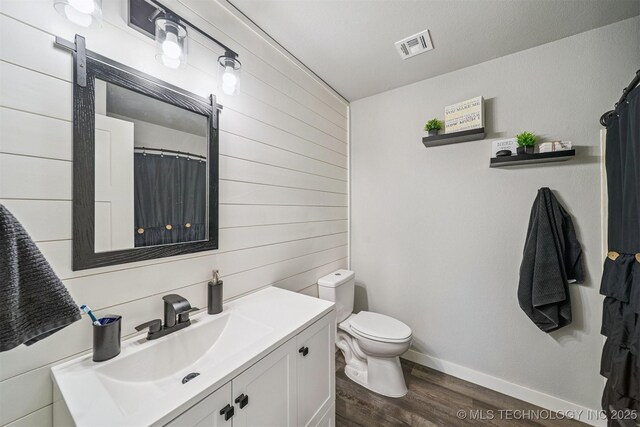 12929 N Sheridan Rd, Collinsville, OK 74021 - full bathroom with wood walls, wood finished floors, and vanity