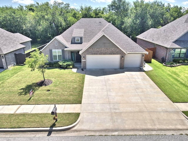 10423 S 233rd E Pl, Broken Arrow, OK 74014 - view of front of home with an attached garage, brick siding, concrete driveway, and a shingled roof