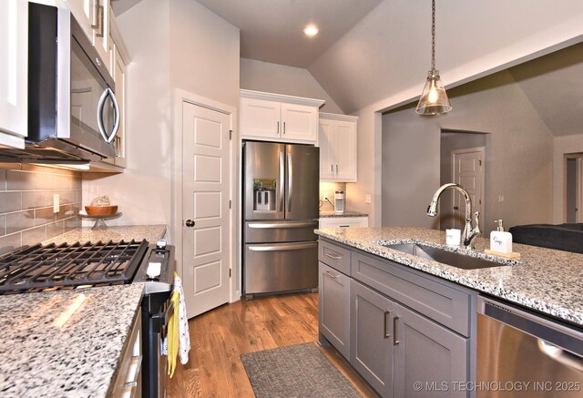 10423 S 233rd E Pl, Broken Arrow, OK 74014 - kitchen featuring stainless steel appliances, lofted ceiling, backsplash, white cabinets, and dark wood finished floors