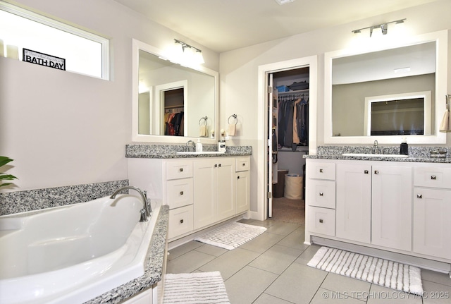 10423 S 233rd E Pl, Broken Arrow, OK 74014 - full bathroom with two vanities, a bath, a walk in closet, and tile patterned flooring