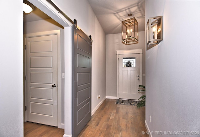 10423 S 233rd E Pl, Broken Arrow, OK 74014 - hallway featuring a barn door and wood finished floors