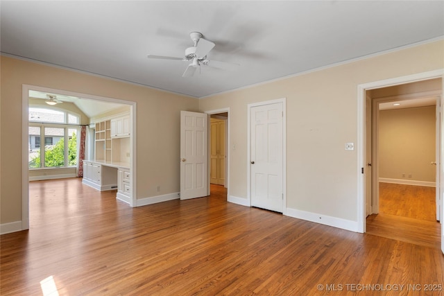 321 E 29th Pl, Tulsa, OK 74114 - unfurnished bedroom featuring light wood-type flooring, built in study area, a ceiling fan, and crown molding