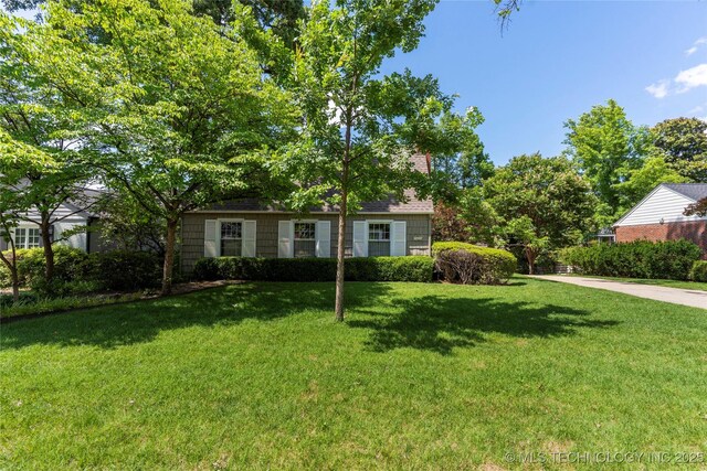321 E 29th Pl, Tulsa, OK 74114 - view of property hidden behind natural elements featuring a front yard