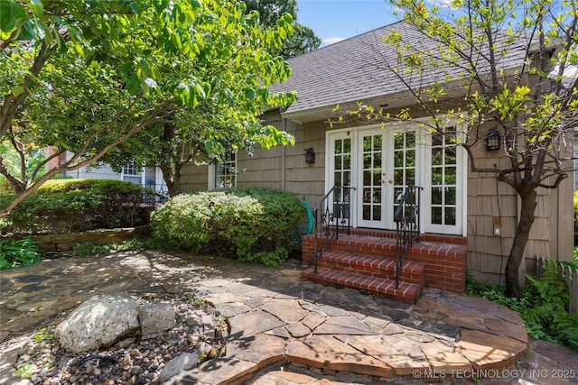321 E 29th Pl, Tulsa, OK 74114 - view of property exterior with french doors, a shingled roof, a patio, and entry steps