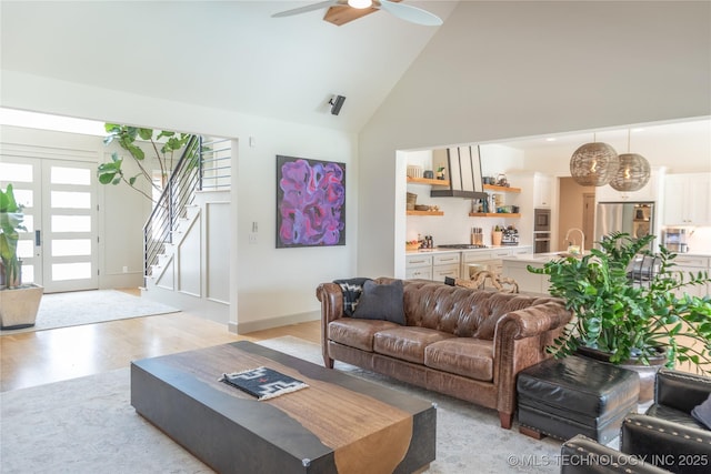 13661 S 23rd St, Bixby, OK 74008 - living area featuring high vaulted ceiling, stairs, a ceiling fan, and light wood-type flooring