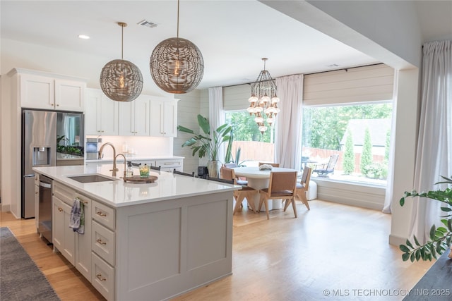 13661 S 23rd St, Bixby, OK 74008 - kitchen featuring healthy amount of natural light, light countertops, white cabinetry, and recessed lighting