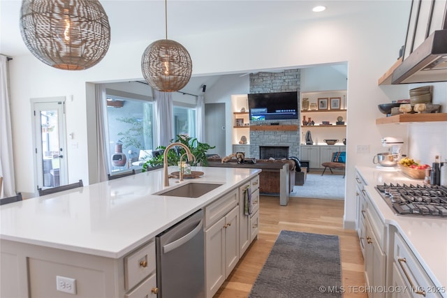 13661 S 23rd St, Bixby, OK 74008 - kitchen with stainless steel appliances, light wood-style floors, extractor fan, light countertops, and a fireplace