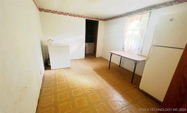 149 S 7th St, Porter, OK 74454 - unfurnished dining area with tile patterned floors, washer / dryer, and radiator heating unit