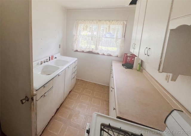 149 S 7th St, Porter, OK 74454 - kitchen featuring light floors, light countertops, and white cabinetry