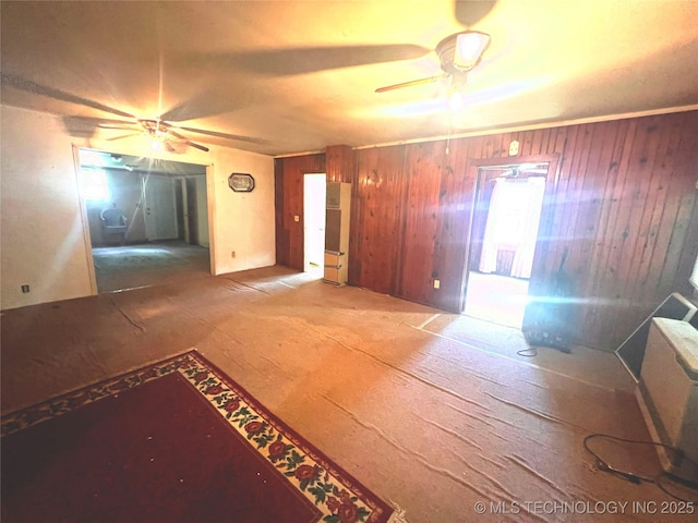 149 S 7th St, Porter, OK 74454 - unfurnished living room with a ceiling fan and wooden walls