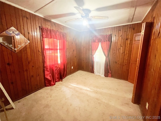 149 S 7th St, Porter, OK 74454 - carpeted empty room with wood walls, a ceiling fan, and crown molding