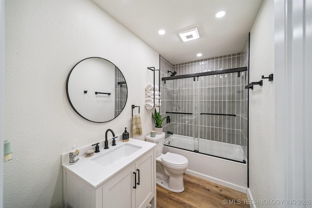 210 NW 4th St, Checotah, OK 74426 - full bath featuring vanity, wood finished floors, enclosed tub / shower combo, and recessed lighting
