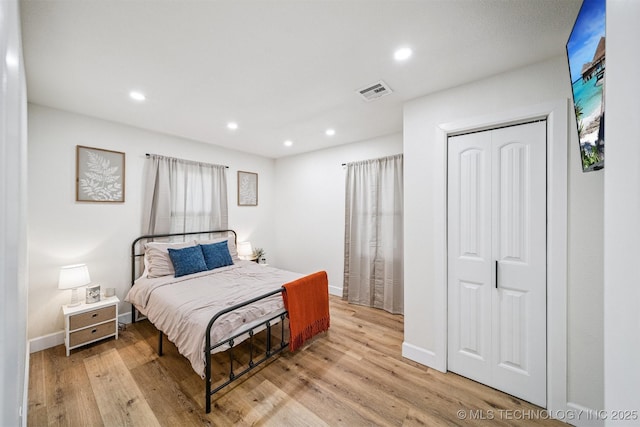 210 NW 4th St, Checotah, OK 74426 - bedroom with light wood-style floors, recessed lighting, and a closet