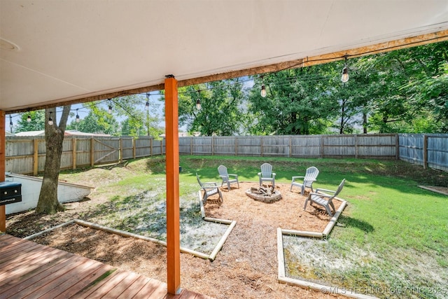 210 NW 4th St, Checotah, OK 74426 - fenced backyard featuring a fire pit