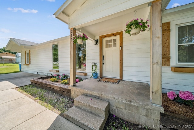 210 NW 4th St, Checotah, OK 74426 - view of exterior entry featuring covered porch