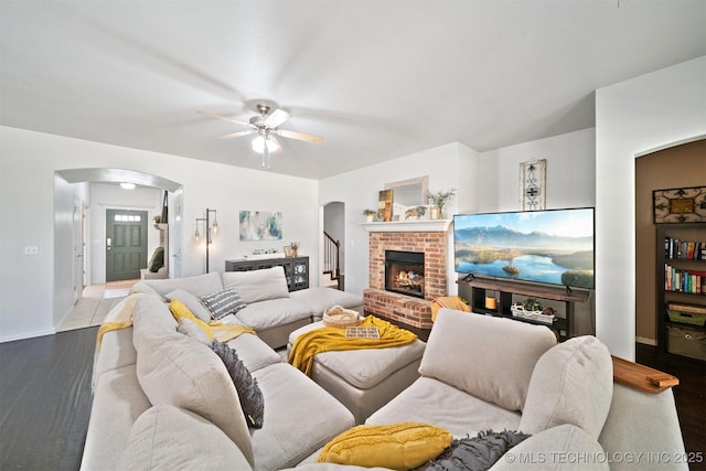 304 S 63rd St, Broken Arrow, OK 74014 - living room with arched walkways, ceiling fan, wood finished floors, and a fireplace