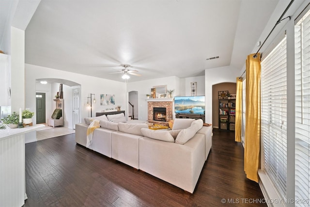 304 S 63rd St, Broken Arrow, OK 74014 - living area with a ceiling fan, arched walkways, a fireplace, and dark wood-style floors
