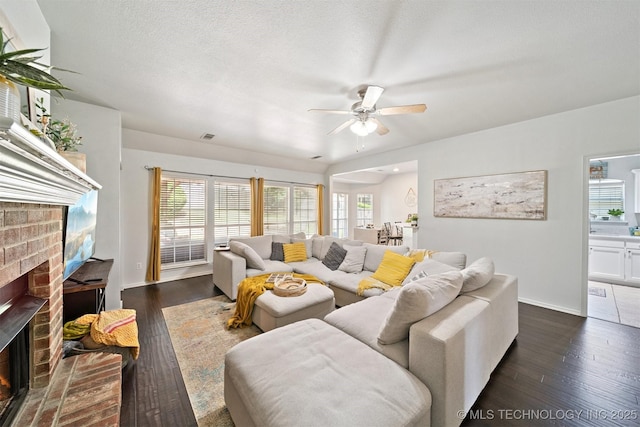 304 S 63rd St, Broken Arrow, OK 74014 - living area featuring a fireplace, ceiling fan, and dark wood-style floors