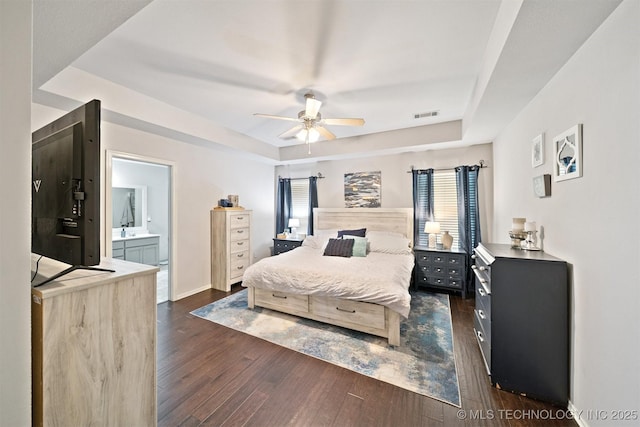 304 S 63rd St, Broken Arrow, OK 74014 - bedroom with a tray ceiling, dark wood-style floors, ceiling fan, and ensuite bath