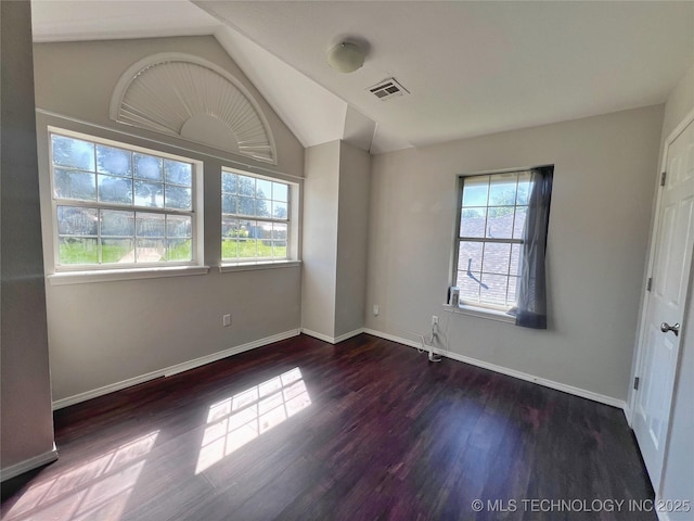 3610 Magnolia Dr, Sand Springs, OK 74063 - empty room with healthy amount of natural light, wood finished floors, and vaulted ceiling