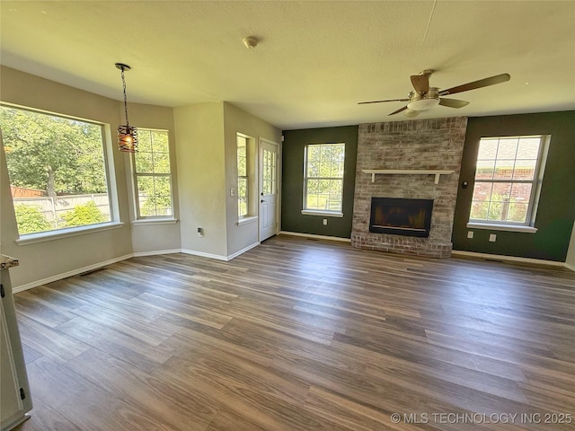 3610 Magnolia Dr, Sand Springs, OK 74063 - unfurnished living room with a ceiling fan, dark wood-type flooring, and a brick fireplace