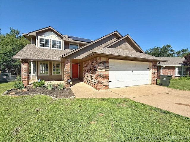 3610 Magnolia Dr, Sand Springs, OK 74063 - view of front of house with an attached garage, solar panels, brick siding, concrete driveway, and a shingled roof
