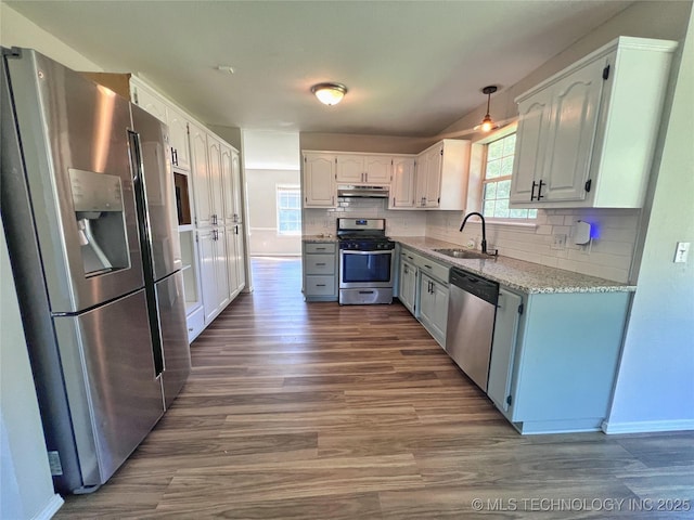 3610 Magnolia Dr, Sand Springs, OK 74063 - kitchen with stainless steel appliances, under cabinet range hood, dark wood finished floors, decorative backsplash, and white cabinets