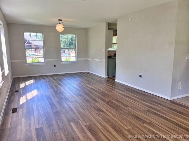3610 Magnolia Dr, Sand Springs, OK 74063 - spare room with baseboards and dark wood finished floors