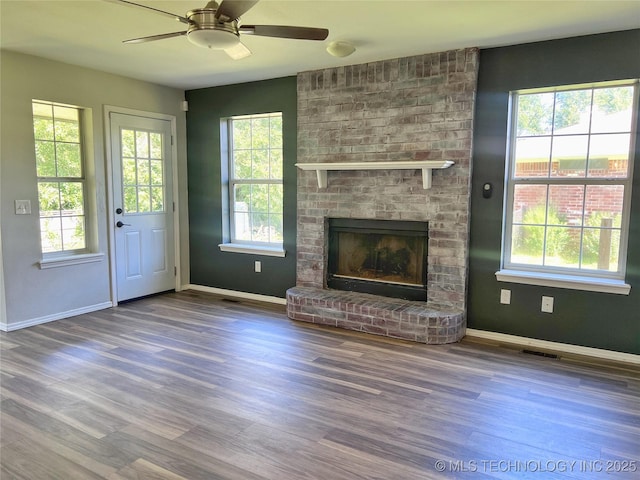 3610 Magnolia Dr, Sand Springs, OK 74063 - unfurnished living room with healthy amount of natural light, wood finished floors, and ceiling fan