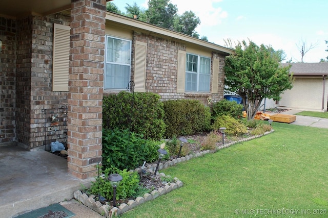 12329 E 18th St, Tulsa, OK 74128 - view of side of home with a lawn and brick siding