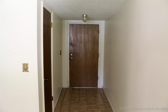 12329 E 18th St, Tulsa, OK 74128 - corridor featuring a textured ceiling and tile patterned flooring