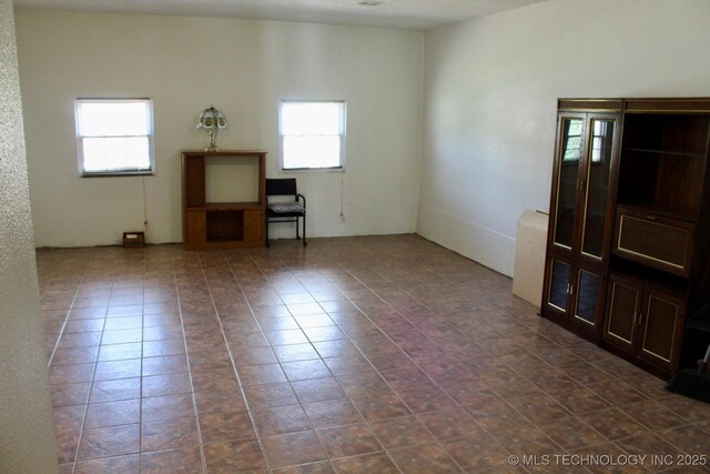 12329 E 18th St, Tulsa, OK 74128 - unfurnished room with dark tile patterned floors