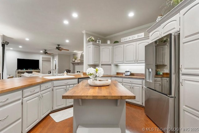 8766 Haskell Dr, Broken Arrow, OK 74014 - kitchen with stainless steel fridge with ice dispenser, butcher block countertops, ornamental molding, a ceiling fan, and recessed lighting