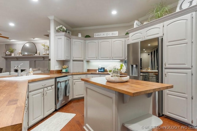8766 Haskell Dr, Broken Arrow, OK 74014 - kitchen with wooden counters, stainless steel dishwasher, a center island, ornamental molding, and wood finished floors