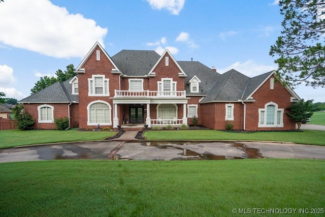 8766 Haskell Dr, Broken Arrow, OK 74014 - colonial house with brick siding, covered porch, and a front yard