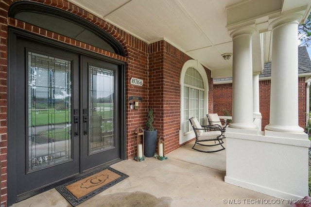 8766 Haskell Dr, Broken Arrow, OK 74014 - view of exterior entry featuring a porch and brick siding