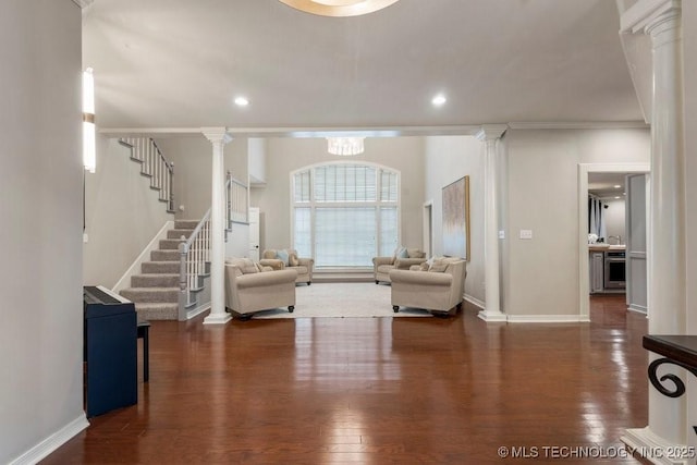 8766 Haskell Dr, Broken Arrow, OK 74014 - living area featuring decorative columns, wood finished floors, stairway, recessed lighting, and crown molding