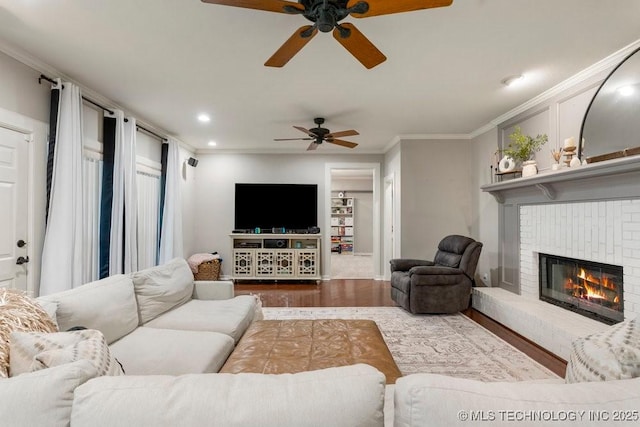 8766 Haskell Dr, Broken Arrow, OK 74014 - living room with ceiling fan, crown molding, wood finished floors, a fireplace, and recessed lighting