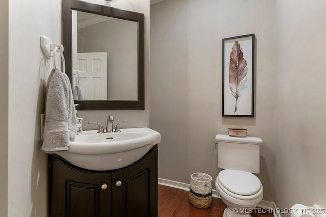8766 Haskell Dr, Broken Arrow, OK 74014 - half bathroom with vanity, wood finished floors, and crown molding