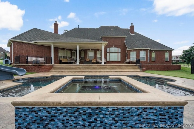 8766 Haskell Dr, Broken Arrow, OK 74014 - back of property with brick siding, an in-ground hot tub, and a chimney