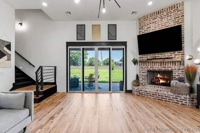 21933 E 101st Pl S, Broken Arrow, OK 74014 - unfurnished living room featuring wood finished floors, a fireplace, stairway, and recessed lighting