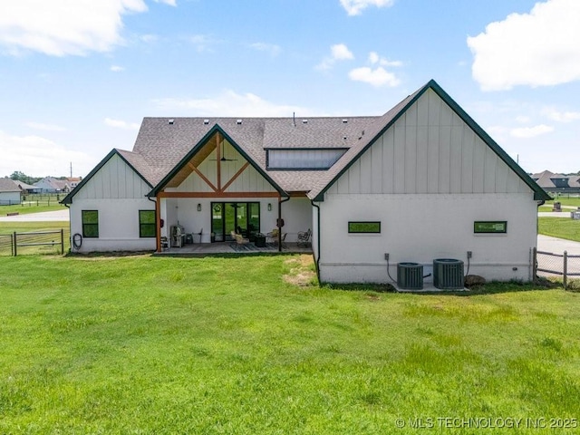 21933 E 101st Pl S, Broken Arrow, OK 74014 - back of house with board and batten siding, roof with shingles, and a patio area