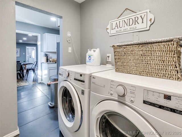 2016 W Easton St, Tulsa, OK 74127 - laundry room featuring washer and dryer and dark tile patterned flooring