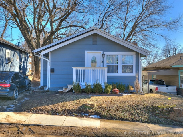 2016 W Easton St, Tulsa, OK 74127 - view of front of house featuring a chimney and a carport
