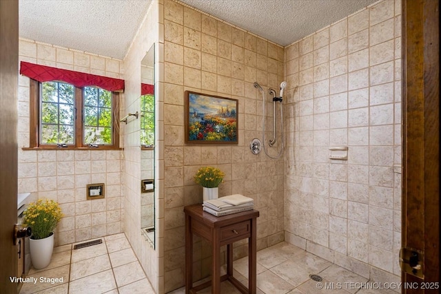 1943 W 163rd St, Skiatook, OK 74070 - full bathroom featuring a textured ceiling, a stall shower, tile walls, tile patterned floors, and vanity