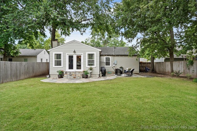 1628 E 45th Pl, Tulsa, OK 74105 - back of property with entry steps, a patio, a fenced backyard, and a chimney