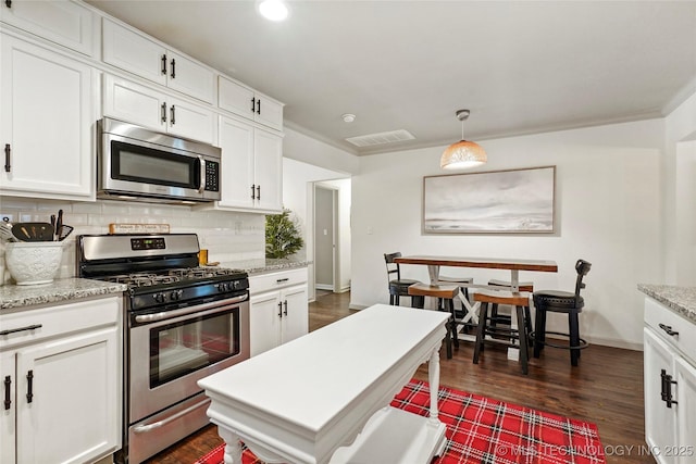 1628 E 45th Pl, Tulsa, OK 74105 - kitchen featuring appliances with stainless steel finishes, tasteful backsplash, white cabinets, dark wood-type flooring, and recessed lighting